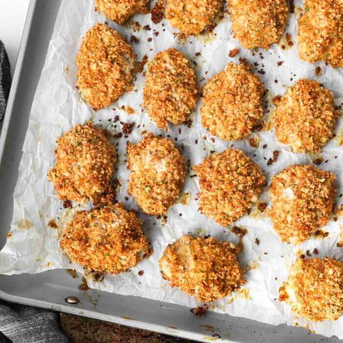 Overhead image of cooked homemade chicken nuggets made with ground chicken on a sheet pan.