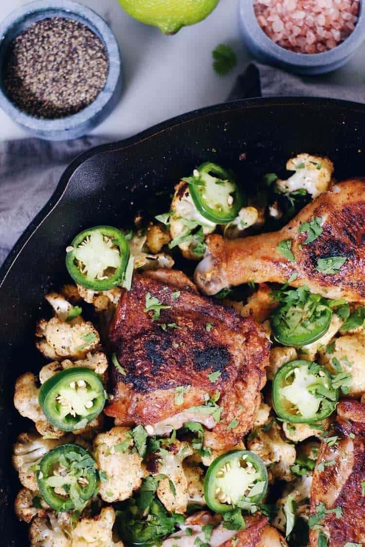 Crispy chicken thighs with zesty cauliflower are the perfect Paleo + Whole30 spicy meal. Packed with flavor, including citrus, cilantro and jalapeño! Paleo + Whole30. | realsimplegood.com