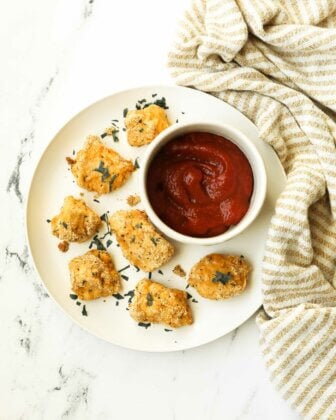 Overhead shot of keto chicken nuggets on a plate with ramekin of ketchup