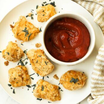 Crunchy keto chicken nuggets on a plate with ketchup