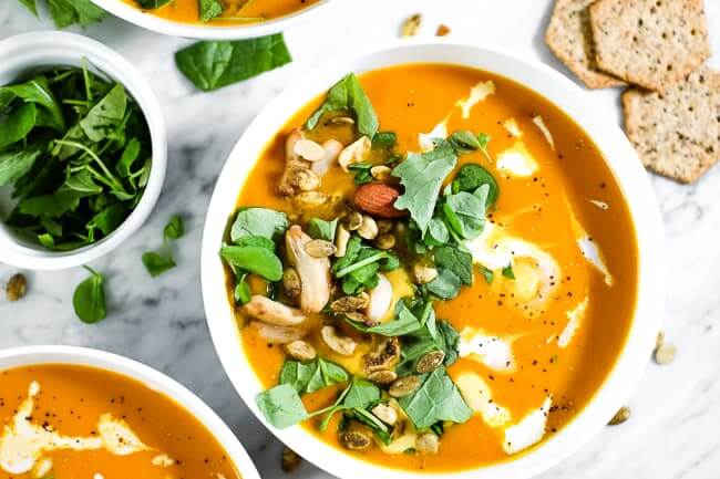 Curried butternut squash soup, topped with chopped greens, trail mix, roasted pepper, coconut milk and ground pepper. Crackers on the side. 