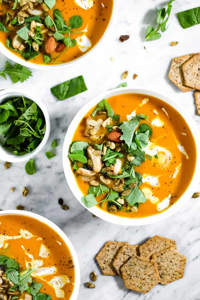 Curried butternut squash soup, topped with chopped greens, trail mix, roasted pepper, coconut milk and ground pepper. Crackers on the side. 