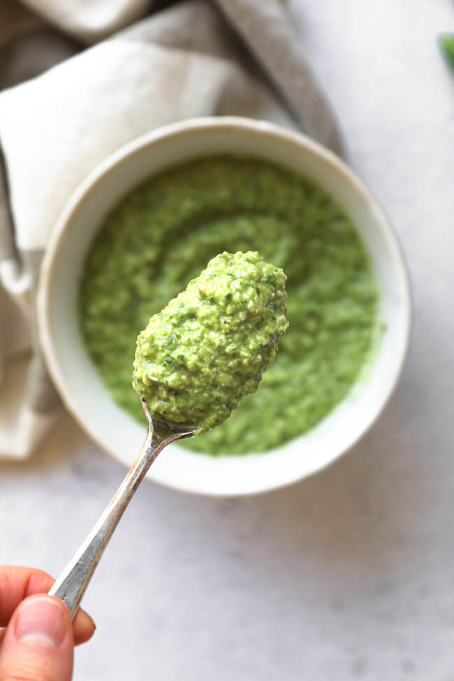 Overhead image of a spoonful of dairy and nut free pesto. 