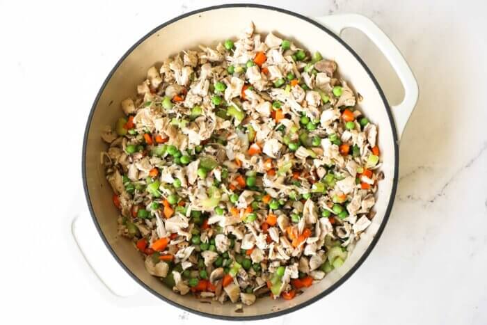 Mirepoix veggies and chicken in a skillet