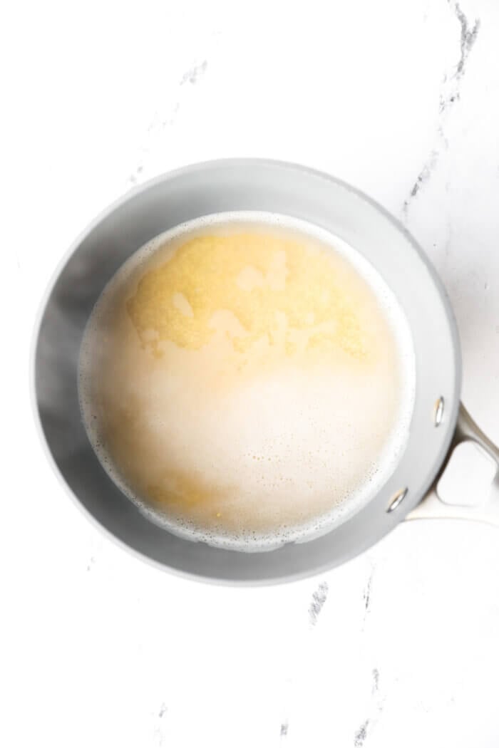 Millet and water in a saucepan after bringing to a boil.