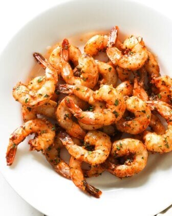 Overhead shot of a plate of smoked shrimp with tails on