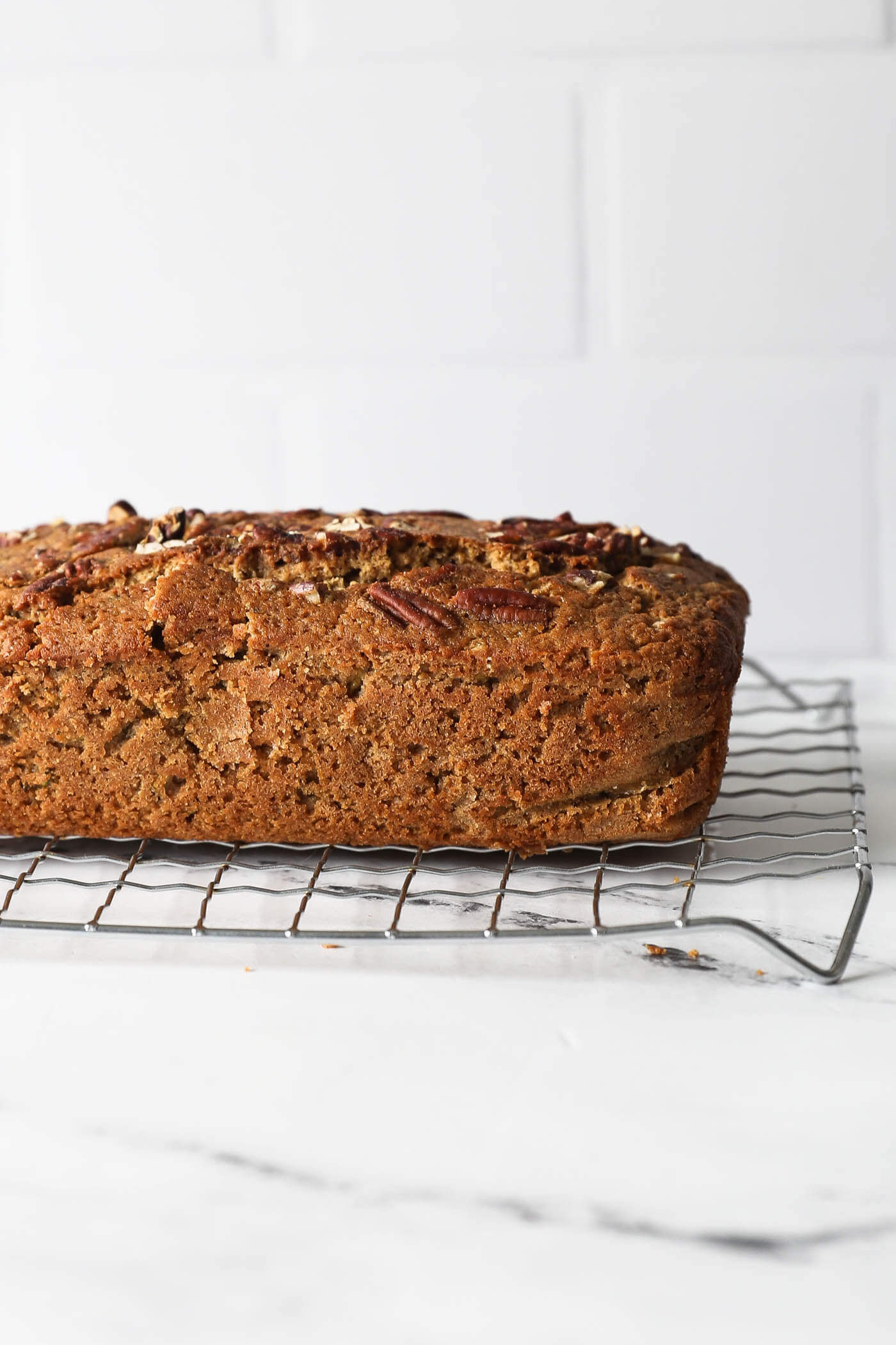 Straight on view of a loaf of zucchini bread on a cooling rack