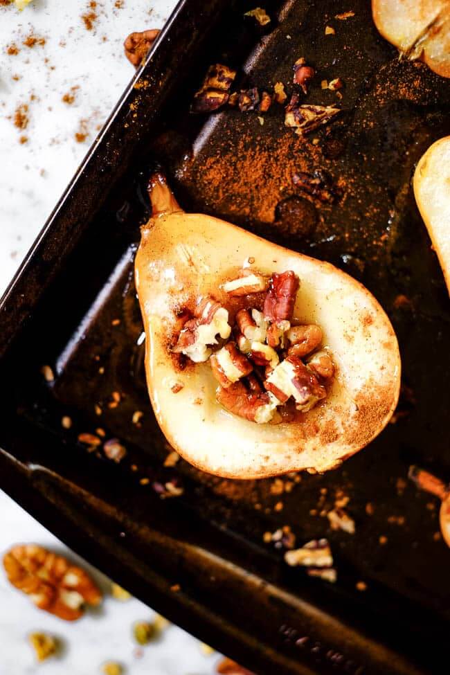 Easy baked pears on a cookie sheet with cinnamon, chopped nuts and honey. 