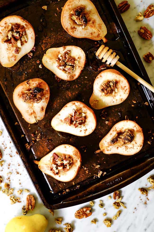 Easy baked pears on a cookie sheet with cinnamon, chopped nuts, granola and honey. 