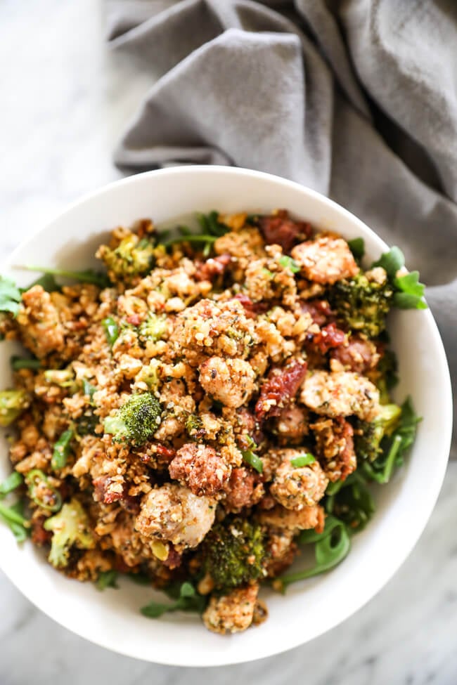 Easy chicken and chorizo bake in a bowl with greens vertical shot