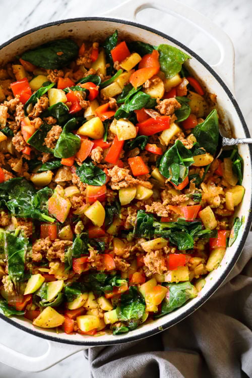 Vertical overhead image of easy chorizo hash in a skillet with a serving spoon.