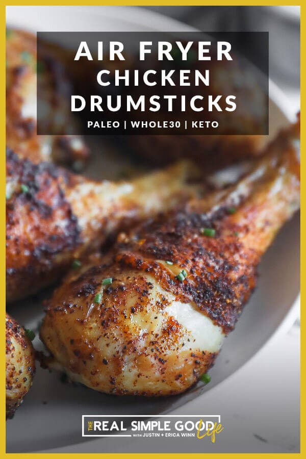 Image with text overlay at top. Close up of chicken drumstick on a plate with chives on top. 