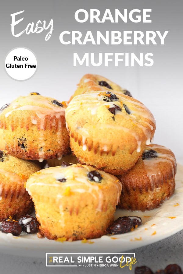 Vertical angled image of orange cranberry muffins stacked on a plate with text overlay at the top. 