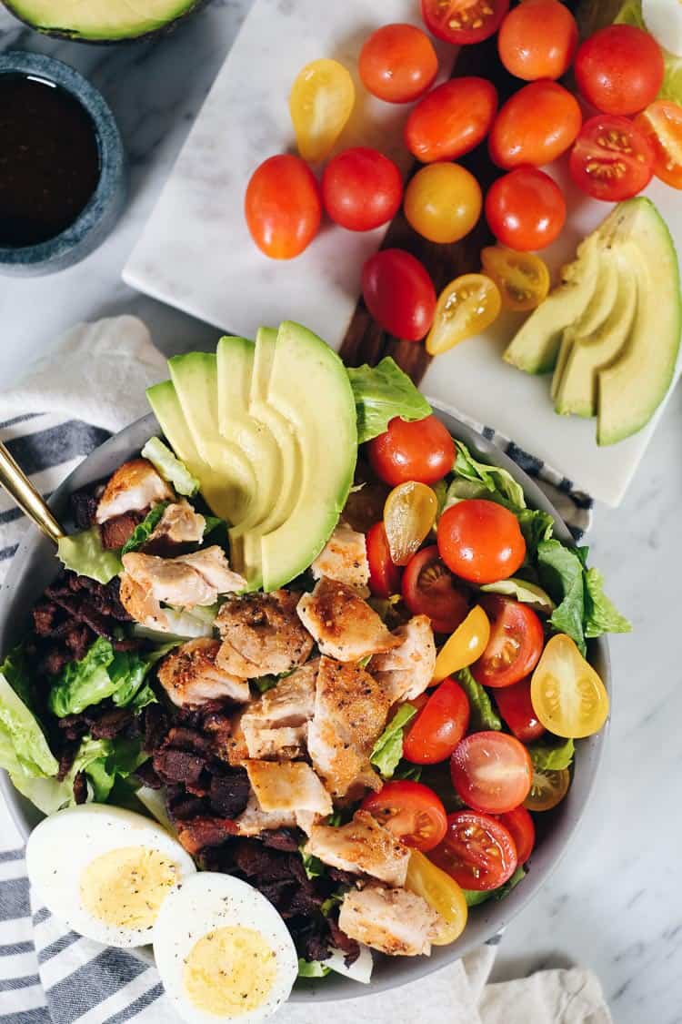 This easy Paleo cobb salad is packed with all the flavors, like smoky bacon, creamy avocado, fresh tomatoes and a tangy balsamic dressing! It's Whole30 too! | realsimplegood.com