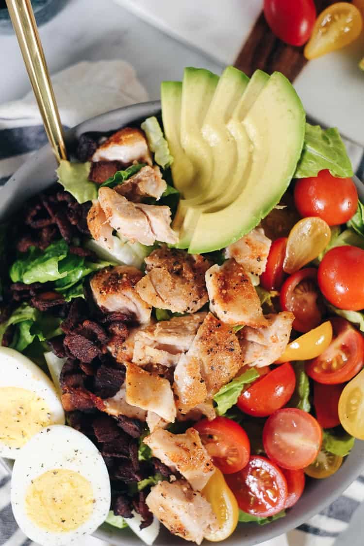 This easy Paleo cobb salad is packed with all the flavors, like smoky bacon, creamy avocado, fresh tomatoes and a tangy balsamic dressing! It's Whole30 too! | realsimplegood.com