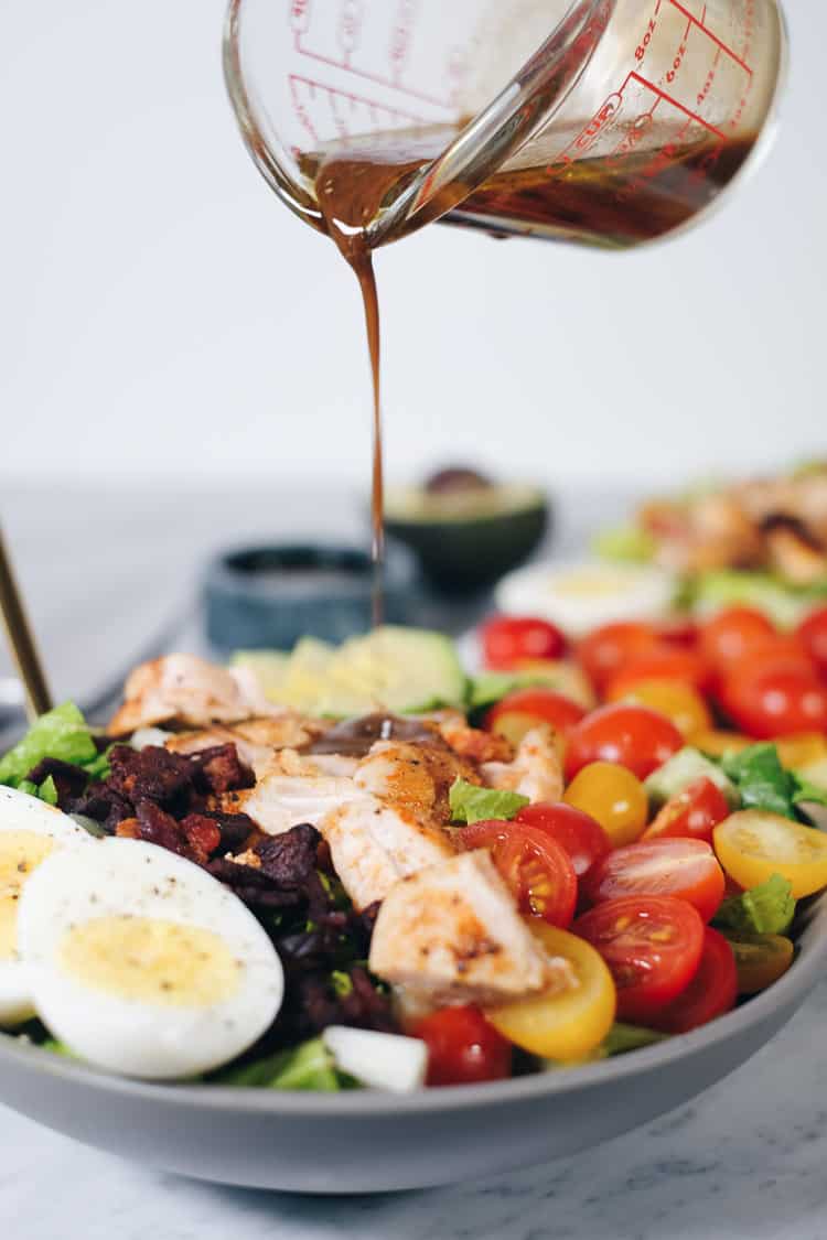 This easy Paleo cobb salad is packed with all the flavors, like smoky bacon, creamy avocado, fresh tomatoes and a tangy balsamic dressing! It's Whole30 too! | realsimplegood.com