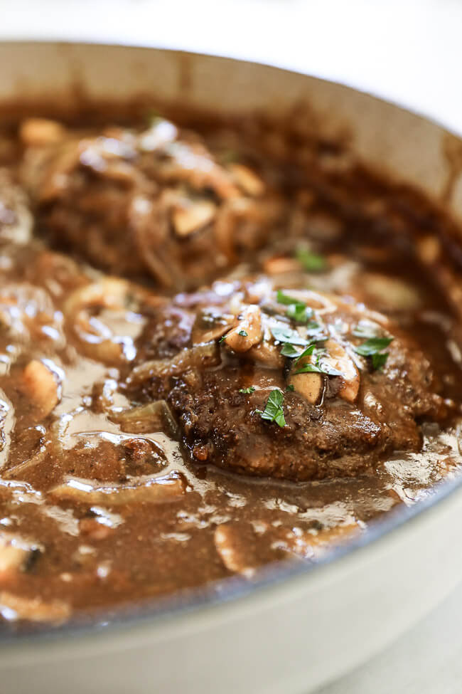 Easy salisbury steak in pan with mushroom and onion gravy. Close up angle shot