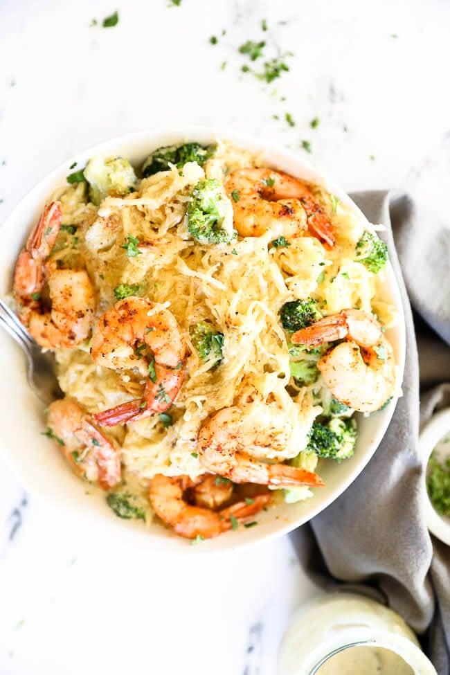 Overhead image of bowl full of shrimp and broccoli spaghetti squash alfredo. 