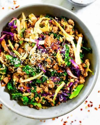 Cabbage egg roll in a bowl with onions and sesame seeds