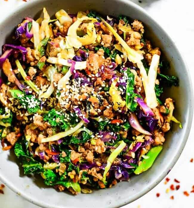 Cabbage egg roll in a bowl with onions and sesame seeds