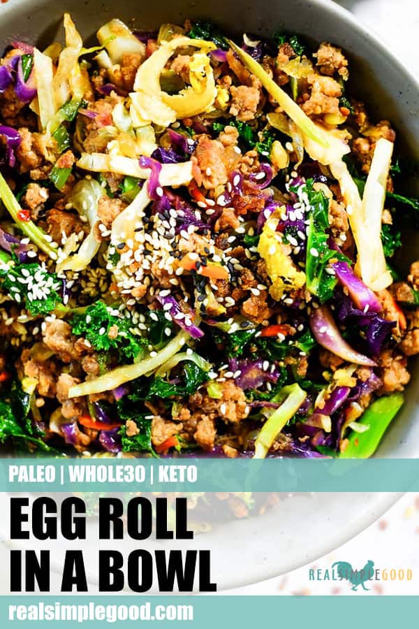 Close up shot of egg roll in a bowl for long pin for pinterest. Sesame seeds on top with cruciferous veggies, ground pork and a savory sauce. 