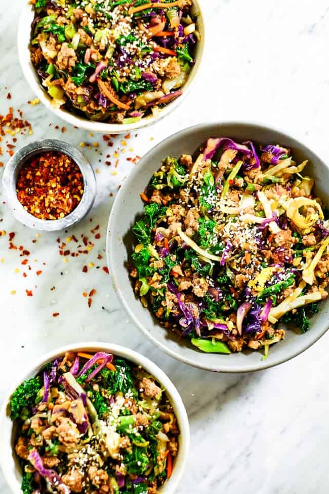 Egg roll in a bowl in three bowls. Made with cruciferous veggies, ground pork and a savory sauce. 