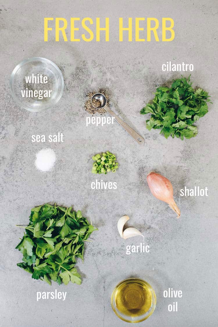 Fresh herb marinade ingredients laid out on gray background with text overlay by ingredients