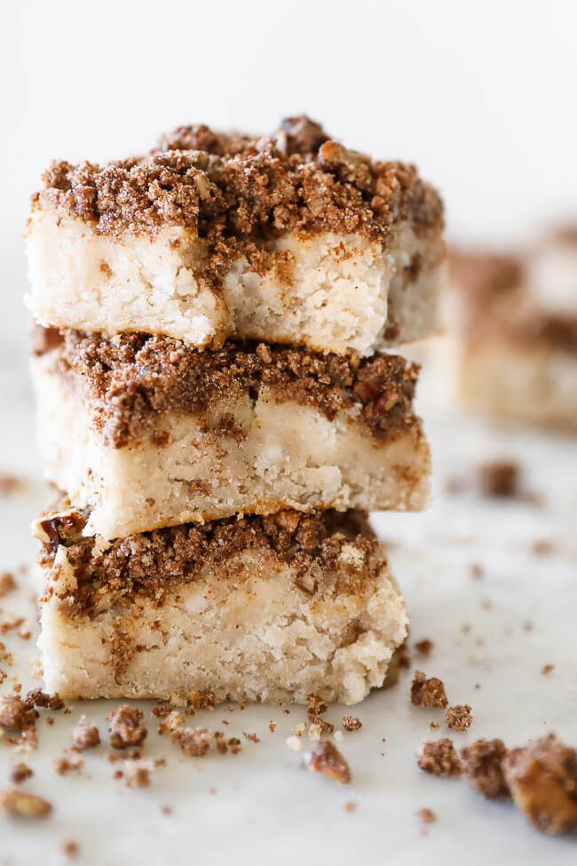 Stack of three gluten free coffee cake squares. Top square with a bite taken out. 