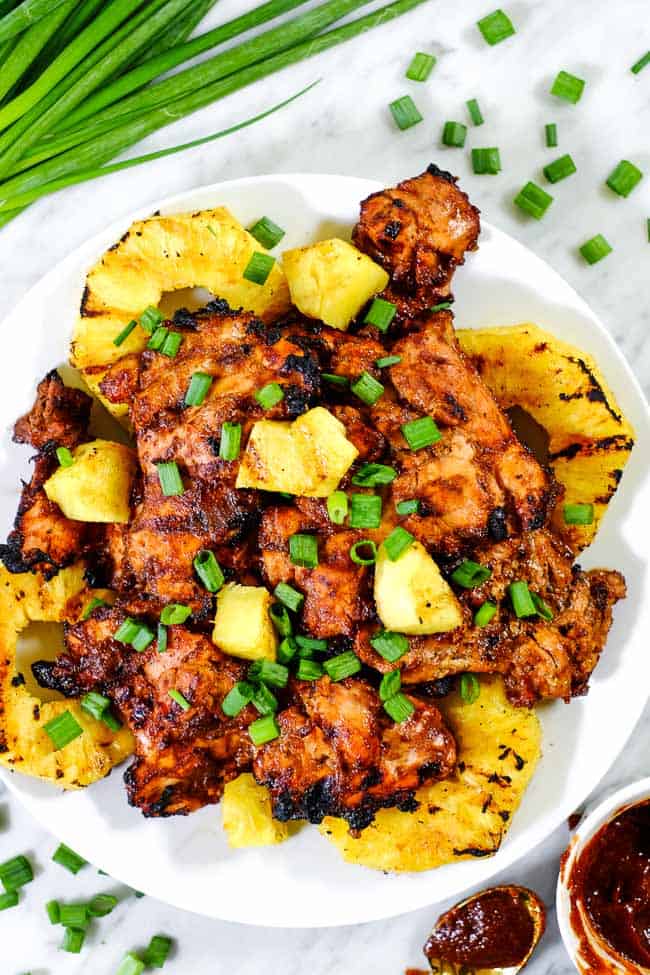 Grilled pineapple chicken on plate with green onions