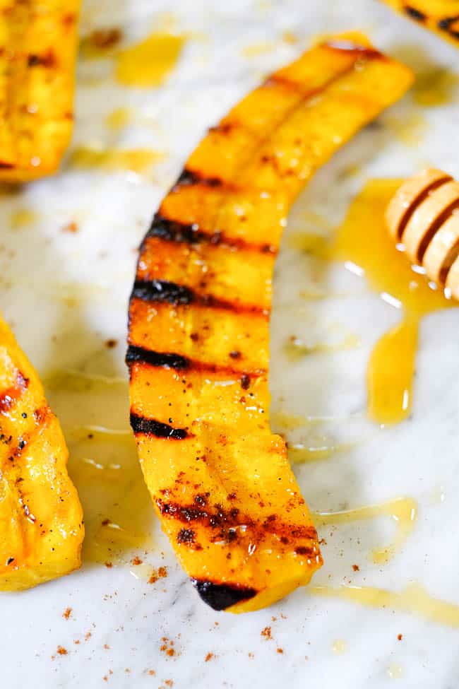 Close up angle shot of grilled plantain with honey and cinnamon.