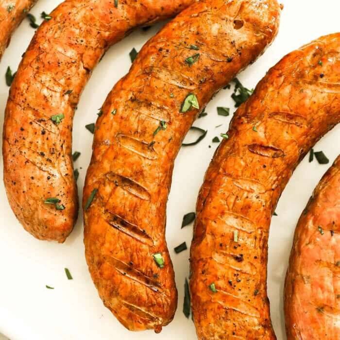 Close up overhead image of sausage links with grill marks