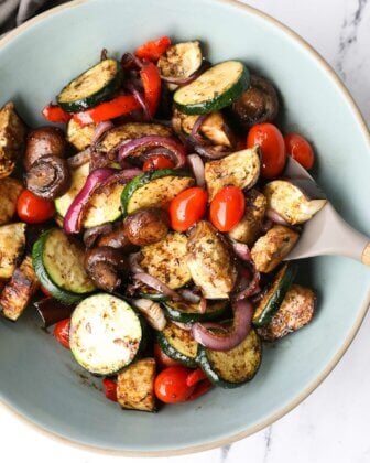 Grilled vegetable marinade tossed with grilled veggies in a bowl.
