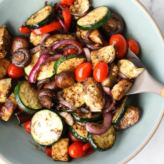 Grilled vegetable marinade tossed with grilled veggies in a bowl.