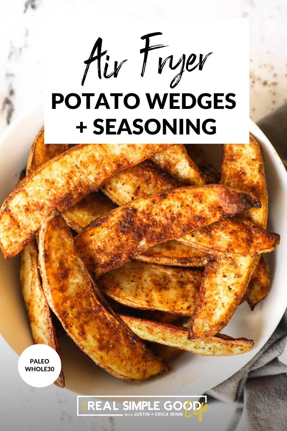 Close up image of air fryer potato wedges in a bowl with text overlay at the top of the image. 