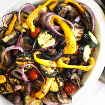 Close up overhead shot of oval bowl filled with grilled vegetables