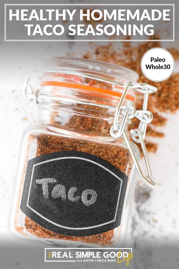 Homemade taco seasoning in a jar laying on the counter with text at top