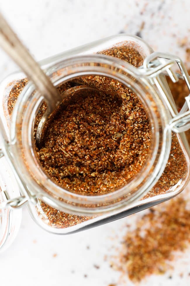 Overhead image of seasoning in a jar with spoon