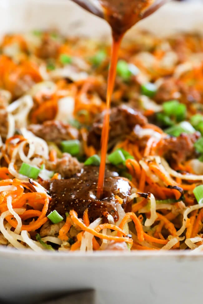 Healthy pork casserole in dish with sauce pouring in close up shot