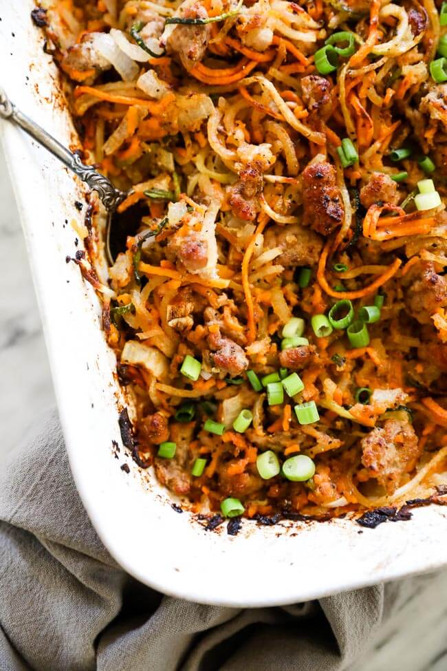 Healthy pork casserole in dish with spoon close up overhead shot