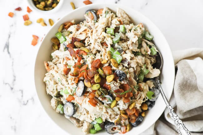 Overhead horizontal image of keto chicken salad in a bowl with a spoon.