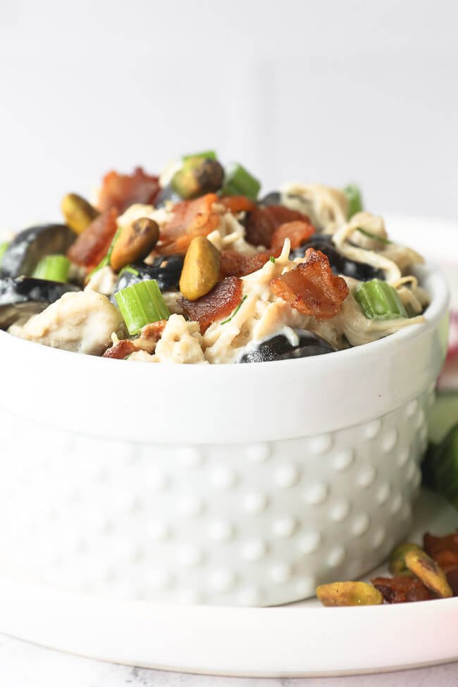 Vertical angled close up of chicken salad in a ramekin. 