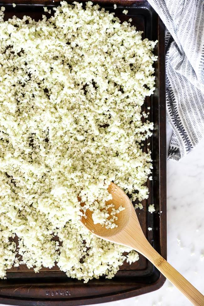 Vertical overhead image of cauliflower rice on a sheet pan. 