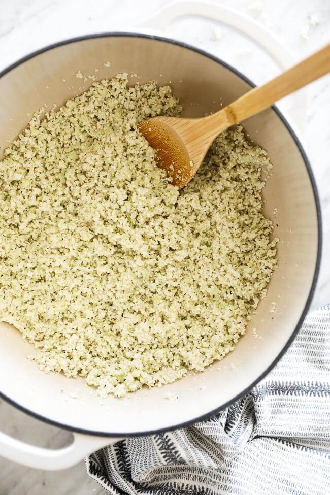 Vertical overhead image of cauliflower rice in a dutch oven. 