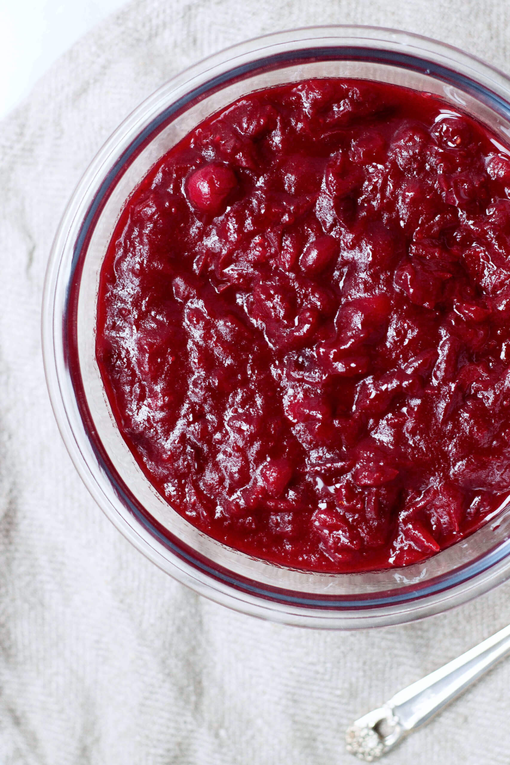 Overhead image of cranberry sauce in a glass bowl