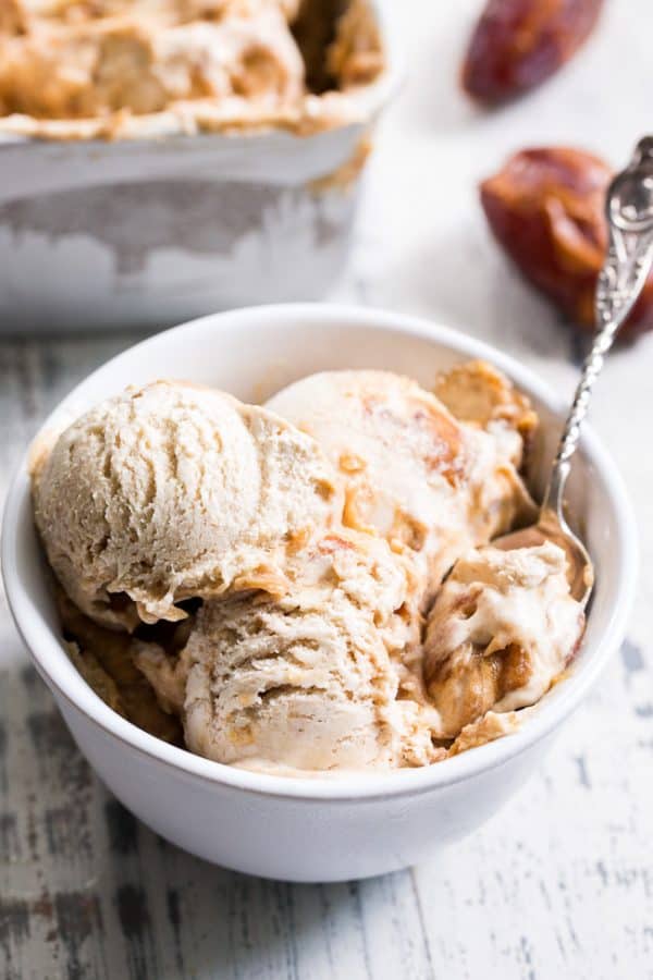 Scoops of salted caramel ice cream in a bowl with a spoon 