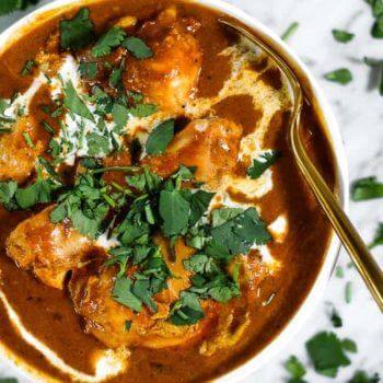 Bowl of instant pot butter chicken with spoon coming out