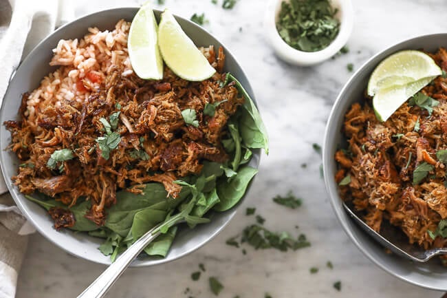 Instant pot carnitas in bowls with rice and spinach horizontal overhead image