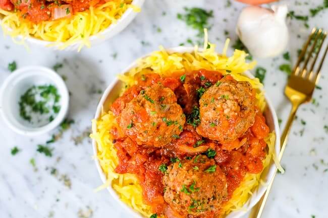 Instant Pot spaghetti and meatballs with parsley, fork and garlic.