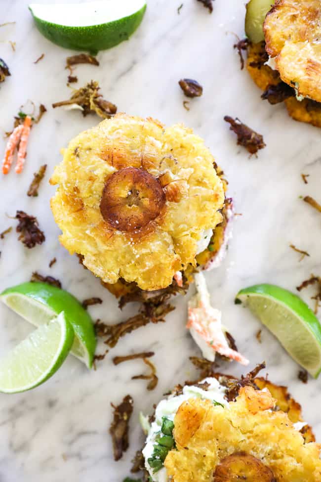 Overhead shot of jibarito recipe with smashed plantain on top. 