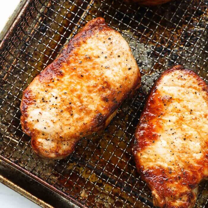 Close up overhead shot of air fryer cooked pork chops from frozen